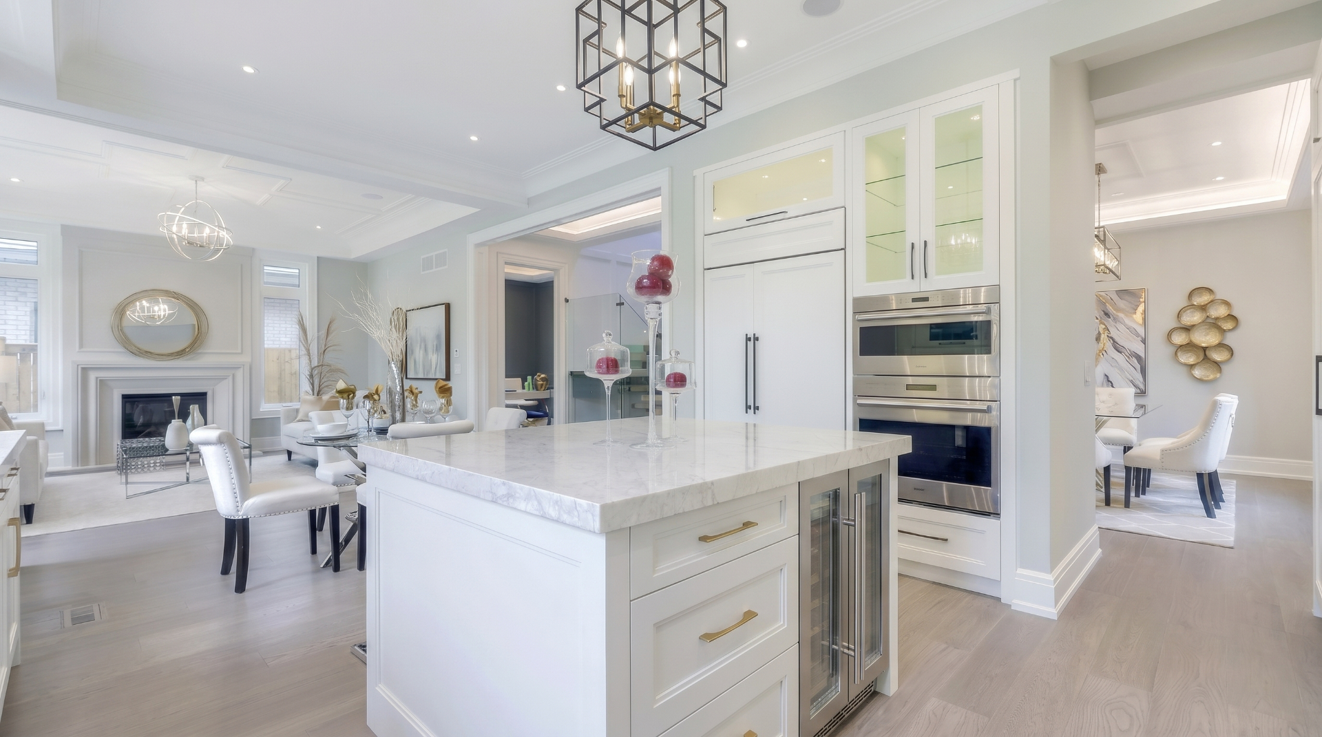 Bright custom kitchen with a large marble island and brushed gold hardware