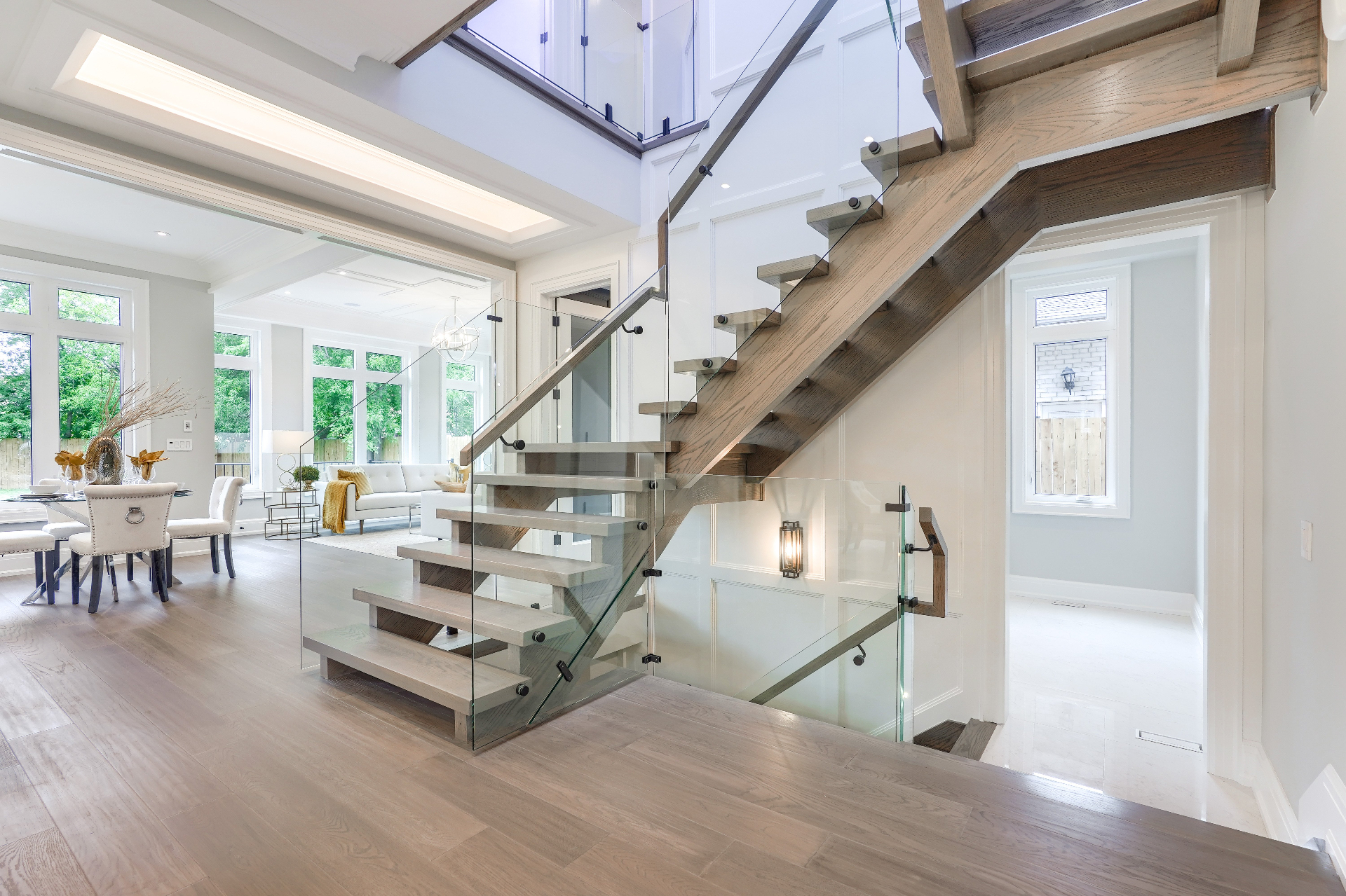 Modern transitional custom home exterior with stone cladding and black-framed windows